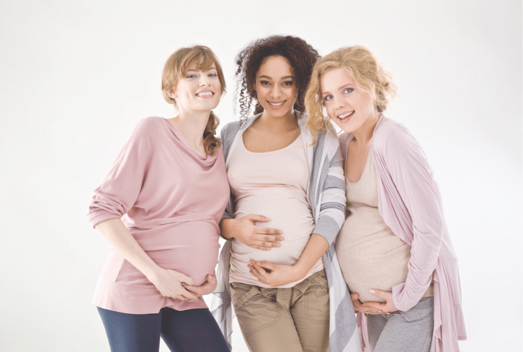 Three pregnant women standing together